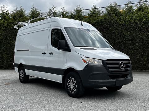 A 2020 Mercedes-Benz Sprinter van with a white exterior and a black bumper parked in a lot
