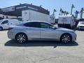 A silver 2017 Acura TLX parked with a sleek profile showcasing its modern design and stylish alloy wheels