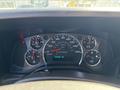 Dashboard of a 2019 GMC Savana showing speedometer fuel gauge and warning lights with a digital display reading 133442 Km