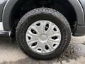 Close-up of a 2017 Ford Transit T150 XLT wheel with a Goodyear Wrangler tire showing a silver and black rim design