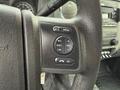 Close-up of the steering wheel controls from a 2013 Ford F-350 SD featuring buttons for media, volume, seek, and an OK function