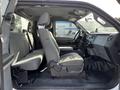 Interior of a 2011 Ford F-450 SD featuring gray upholstered seats and a dashboard with controls and displays