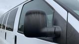 A 2017 Chevrolet Express Quigley 4x4 showing the driver's side mirror with a sleek design and a black cover