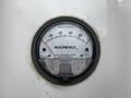 A pressure gauge labeled Magnehelic measuring inches of water pressure on a Huntair Custom Air Handler Unit