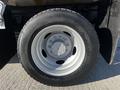 Close-up of a wheel and tire from a 2008 Ford F-450 SD showing a silver rim and a black tire with visible tread patterns