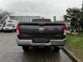 A 2020 RAM 3500 truck with a dark exterior is shown from the rear with a prominent RAM logo on the tailgate and dual exhaust tips visible