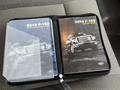 A 2010 Ford F-150 owner's guide and quick reference guide placed in a black zippered binder