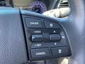 Close-up of the steering wheel controls for cruise control in a 2017 Genesis G80 featuring buttons for cruise set, resume, and cancel functions