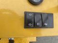 A close-up view of the control panel of a 2024 AGT KRW 23 Mini loader featuring three toggle switches for directional controls and lights