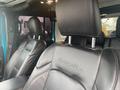 Interior view of a 2020 Jeep Wrangler featuring black leather seats with the word Sahara embossed on the headrest