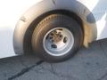 A close-up of the wheel and tire of a 2016 Chevrolet Express showing a silver rim with multiple bolt holes and a black tire with visible tread patterns