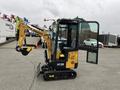 A 2024 AGT Industrial Yellow H13R Mini Excavator with a tracked base and a front digging arm is positioned with an open cabin and controls visible inside
