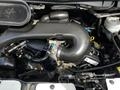 A detailed view of the engine compartment of a 2018 Ford Transit showcasing various components such as hoses and the air intake system