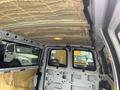 Interior view of a 2012 Chevrolet Express van showcasing the ceiling insulation and interior panels without any windows or seats visible