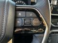 Close-up of the steering wheel control panel of a 2023 Toyota Tundra featuring buttons for cruise control and audio settings