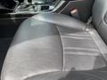 A close-up of a black leather driver's seat in a 2015 Kia Sorento showing stitching details and textured material