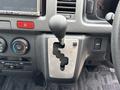 A gear shift lever of a 2009 Toyota Hiace with markings for various drive modes including park neutral drive and low