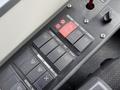 Close-up of control panel buttons in a 2018 Grande West Vicinity bus featuring various switches for lights and systems with red emergency button visible