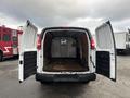 A 2022 GMC Savana with its rear doors open revealing a spacious interior designed for cargo transport