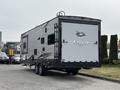 A 2021 Jayco Jay Flight travel trailer with a silver and black exterior design featuring a large rear door and the Jayco logo prominently displayed on the back