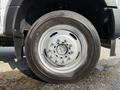 Close-up of a silver wheel on a 2022 Ford F-550 showcasing the tire tread and lug nuts