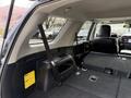 Interior view of a 2021 Toyota 4Runner showing the rear seating area with seats folded down and storage compartments visible