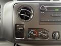 Dashboard controls of a 2019 Ford Econoline featuring an air vent and climate control knobs for adjusting temperature and airflow settings