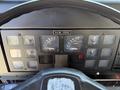 The dashboard of a 1991 International 4600 featuring several gauges for speed temperature and pressure along with various control buttons