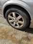 A close-up view of the wheel of a 2002 Nissan Maxima featuring a silver alloy rim and a Michelin tire