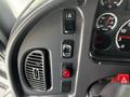 Control panel of a 2010 Freightliner M2 106 featuring various switches gauges and indicators for oil water and temperature