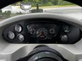 Dashboard of a 2015 Spartan School Bus featuring gauges for speed, fuel, temperature and warning lights