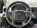 Steering wheel of a 2008 Ford F-550 with a Ford logo and dashboard instruments visible behind it