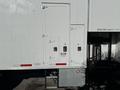 A white 2011 Freightliner M2 106 truck with a cargo area accessed via an enclosed door and steps at the rear