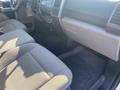 Interior view of a 2017 Ford F-150 showing the front seats dashboard and floor mats with a simple layout and fabric upholstery