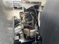 A close-up view of the engine compartment of a 2008 Mitsubishi Fuso FE180 showcasing various components and machinery parts