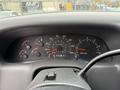 Dashboard of a 2000 Ford F-450 showing various gauges including speedometer, tachometer, fuel gauge, and odometer displaying 911468 miles