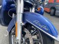 A close-up of the front wheel and fender of a blue 2017 Harley-Davidson FLHTKL showcasing the Electra Glide logo and brake system details