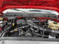 Engine compartment of a 2013 Ford F-550 showing various components such as the air intake manifold batteries and hoses