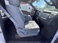 Interior view of a 2012 Ford F-150 showing the driver's side seat with gray upholstery and console