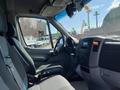 A 2010 Mercedes-Benz Sprinter van interior featuring driver and passenger seats with a dashboard and steering wheel visible