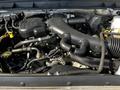 A 2016 Ford F-550 engine with various hoses and components visible including the air intake and alternator