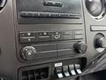 Control panel of a 2017 Ford F-750 featuring climate controls audio system buttons and auxiliary switches