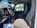 A 2012 Chevrolet Express interior showing the driver's seat and steering wheel with dashboard controls visible