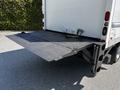 A 2018 Hino 195 truck with a lowered hydraulic lift gate at the back displaying a textured surface for loading and unloading cargo