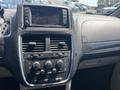 Dashboard of a 2020 Dodge Grand Caravan featuring a touchscreen display and various control buttons for audio and climate settings