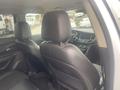 Interior view of a 2018 Buick Encore showing the back seats and the dashboard with a steering wheel and center console visible
