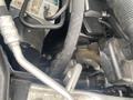 Close-up of a 2009 BMW X5 engine with visible hoses and components including a metallic part and a rubber hose