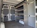 2019 Mercedes-Benz Sprinter cargo van interior with metal shelving on one side and large double doors at the rear