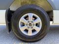 Close-up of a 2023 Mercedes-Benz Sprinter wheel showcasing a silver alloy rim with the Mercedes-Benz logo and a black tire with visible tread details