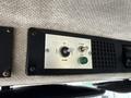 Control panel of a 1998 Freightliner FL80 showing switches for up, down, flood, and spot lighting along with a green button